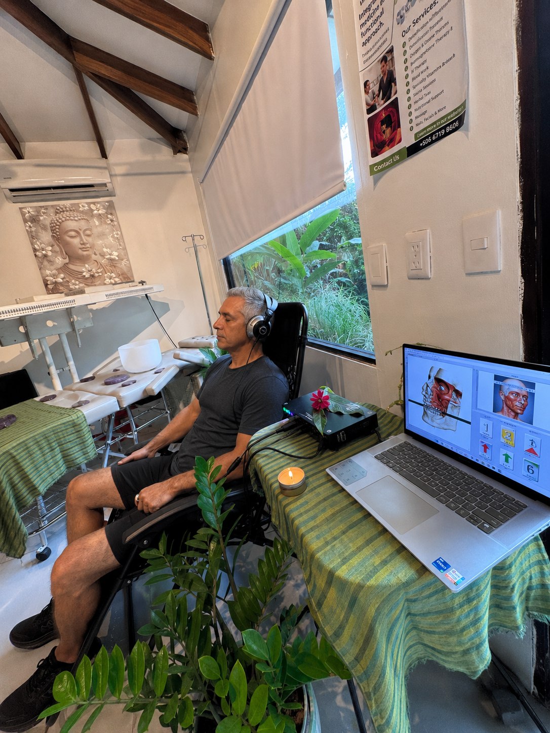 A Vitalara client seated beside the biofeedback results display